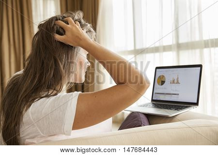 worried middle aged woman looking at her finances