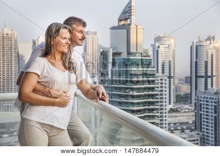 middle aged couple enjoying the view from a balcony