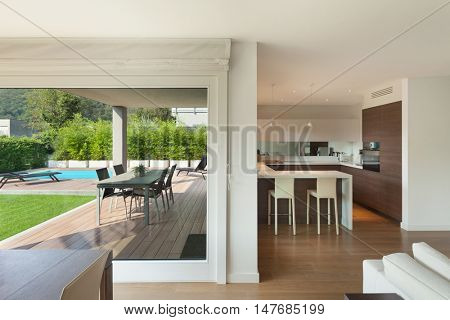Luxury home interior, wide open space, veranda and garden view from the window