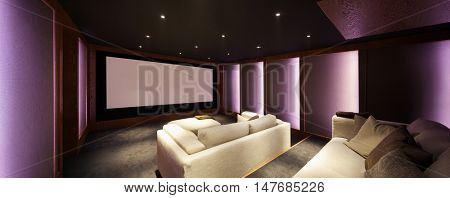 Home theater, luxury interior, comfortable divan and big screen