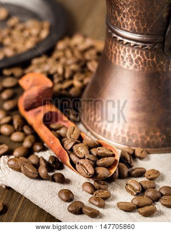 Handmade showel with coffee beans and turkish coffee brewing pot
