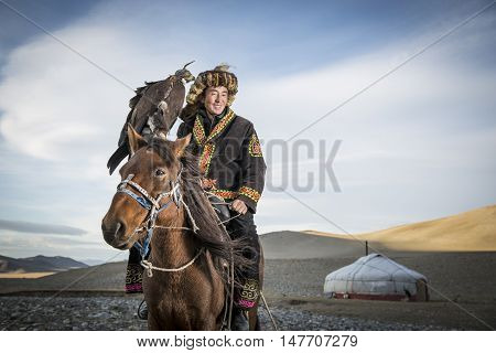 Bayan Ulgii Mongolia September 30th 2015: Mongolian eagle hunter with his eagle and horse