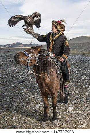 Bayan Ulgii Mongolia September 30th 2015: Mongolian eagle hunter with his eagle and horse