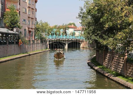 ESKISEHIR TURKEY - SEPTEMBER 04 2016: People in Gondola tour in Porsuk river. Porsuk river is one of the most populer touristy place with boat tours and entertainment in Eskisehir.
