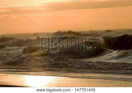 Large and rough waves at sunrise as hurricane hermene sits off shore