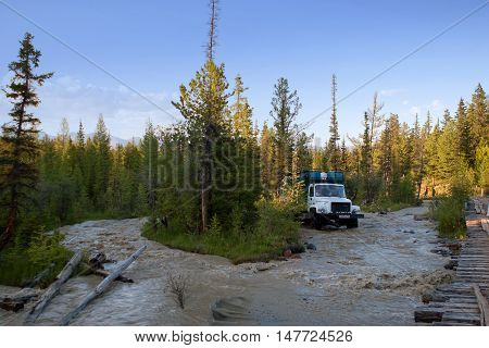 ALTAY, RUSSIA - JULY 20, 2007: Vehicle driving over river in Siberia, Altay.