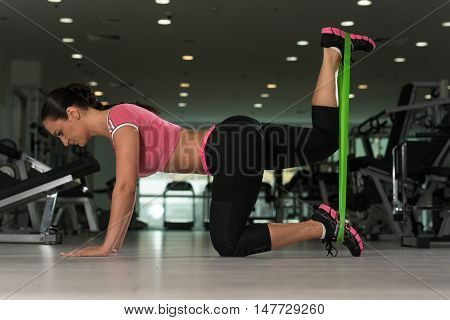 Attractive Woman Working Out With Rubber In Gym