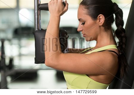 Woman Training Chest Exercises On A Butterfly Machine
