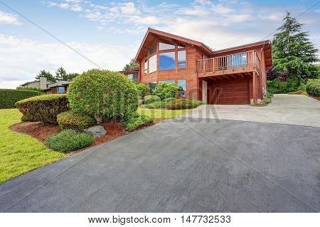 Luxury House Exterior With Wooden Pannel Trim, Garage And Well Kept Garden Around.