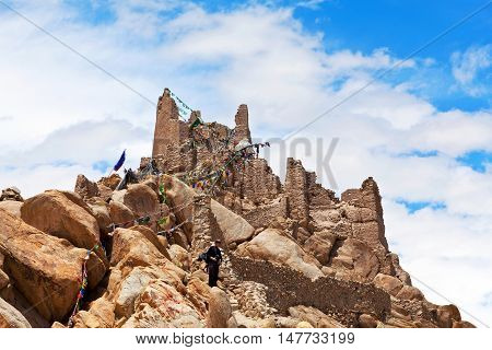 LEH, INDIA - JUNE 11, 2012: Tourist walking at the ancient Shey Palace. Shey Palace complex located on a hillock in Shey 15 kilometres to the south of Leh.