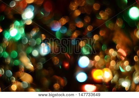 Bright christmas eve background. Plenty of golden sparkling bokeh from defocused garland lights. Backdrop for design