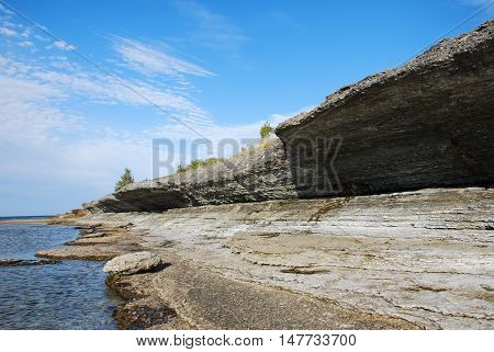 Eroded limestone cliffs hangs over the coastline at the swedish island Oland the island of sun and wind