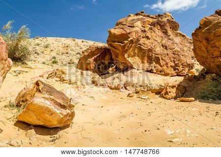 Boulders on the hill in Makhtesh Gadol or Large Crater, nature reserve in Negev desert, Israel