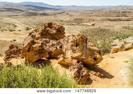 Boulders on the hill in Makhtesh Gadol or Large Crater, nature reserve in Negev desert, Israel