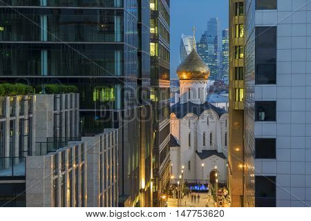 Temple of St. Nicholas in Tverskaya Zastava between two office buildings in evening Moscow, Russia