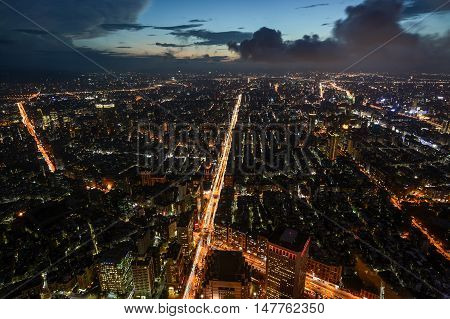 Beautiful aerial night view of Taipei, Taiwan with busy traffic light trails on the Xinyi Road