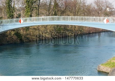 Pedestrian bridge steel arch structure over the river Ruhr in Muelheim Germany.