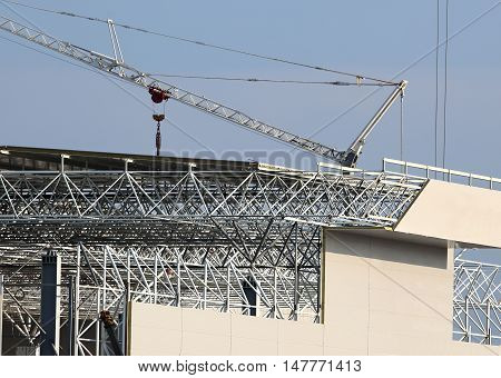 Construction site. Installation of coverings on a skeleton of industrial building during construction
