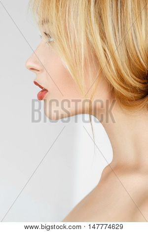 Close-up profile of redhead woman. Beautiful attractive girl with freckles and healthy glow skin side view portrait.