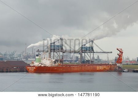ROTTERDAM, THE NETHERLANDS - SEPTEMBER 22, 2015: MS Berge Stahl being unloaded in the Port of Rotterdam. Once the largest iron ore carrier, about to be decommissioned in autumn 2016.