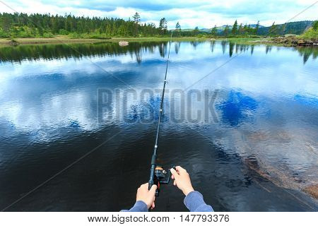 A young man fly-fishing in Kongberg Norway