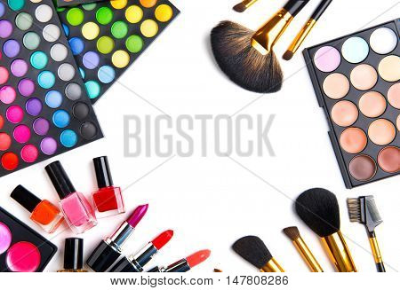 Makeup. Make-up Set Palette with colorful eyeshadows. Various cosmetics Brushes, lipgloss, lipstick, rouge, eyeshadow tints, foundation isolated on a white background. Make up artist tools
