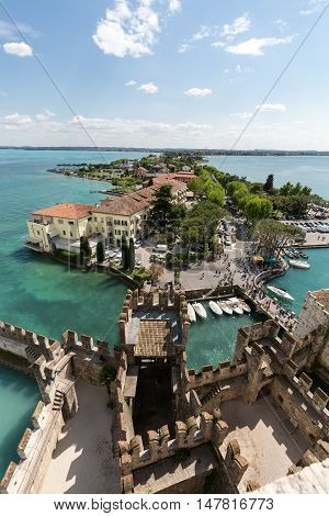SIRMIONE ITALY - MAY 5, 2016: View of colorful old buildings in Sirmione and Lake Garda from Scaliger castle wall Italy