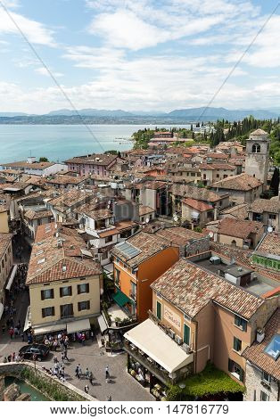 SIRMIONE ITALY - MAY 5, 2016: View of colorful old buildings in Sirmione and Lake Garda from Scaliger castle wall Italy