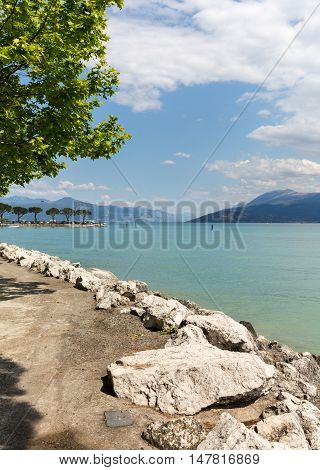 Landscape of the coast of Sirmione peninsula which divides the lower part of Lake Garda. It is a famous vacation place for a long time in northern Italy.