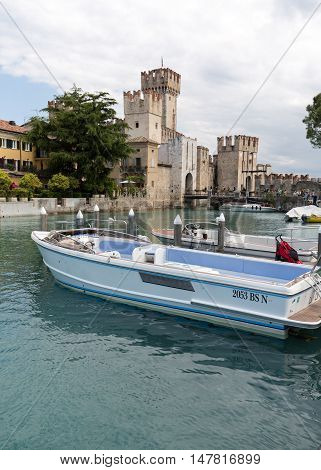 SIRMIONE ITALY - MAY 5, 2016: Sirmione - Italian small city on Garda lake with boats and castle