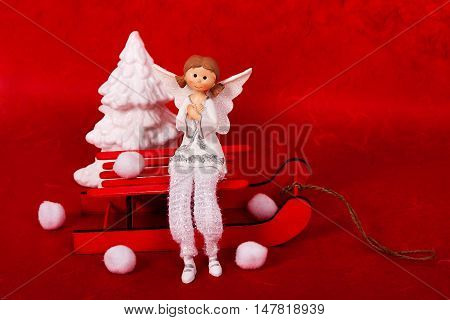 Christmast tree White Christmas angel on red wooden background
