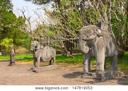 Stone statues of horse, elephant and man in Imperial Minh Mang Tomb of the Nguygen dynasty in Hue, Vietnam. UNESCO world heritage site
