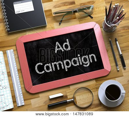 Ad Campaign on Small Chalkboard. Ad Campaign Handwritten on Red Small Chalkboard. Top View of Wooden Office Desk with a Lot of Business and Office Supplies on It. 3d Rendering.