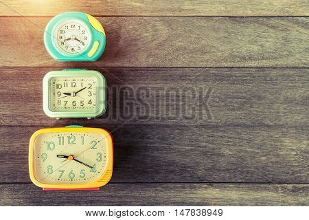 Retro alarm clocks on wood table. Retro or vintage color filtered. Old time concept. Nostalgia concept.