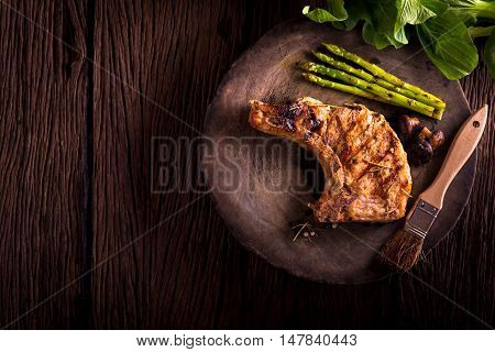 grilled pork chop with vegetable on wooden board