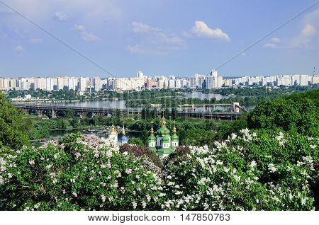 spring day in blossoming lilacs church into phonemes river and big city