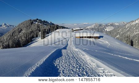 Winter hiking and sledging path on Mt Hohe Wispile Gstaad. Travel destination in the Swiss Alps.