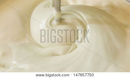 close up of twist white cream spiining in the blow
