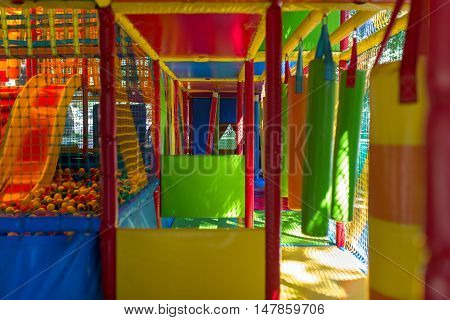 Cute little girl have fun at soft outdoor playground.