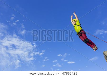 The first jump off the cliff with a safety rope.