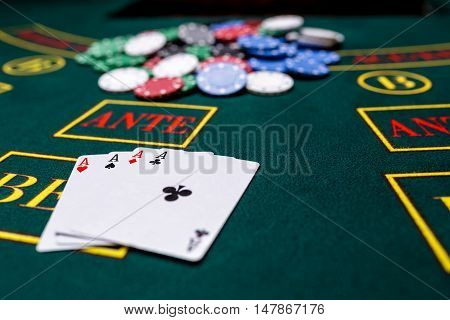 Poker chips on a poker table at the casino. Closeup. four aces, a winning combination. Chips winner