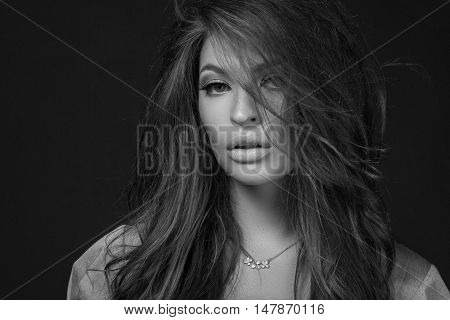 Close Up Portrait Of A Beautiful Girl With A Voluminous Hair And Professional Make-up On A Backgroun