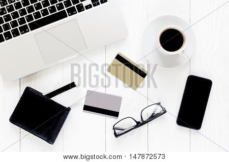 Online shopping concept with creadit cards, laptop and coffee
