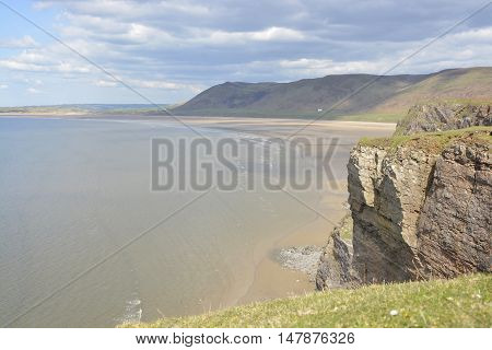 Rhossili Bay with distant people on beach. Gower Peninsular Wales UK