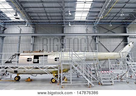 Detail with helicopter fuselage on the repair line in a factory