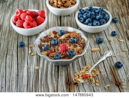 Healthy Coconut Granola with Nuts, Gogi Berry and Berries. Healthy breakfast. Selective focus.