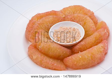 pomelo in dish and isolated white background
