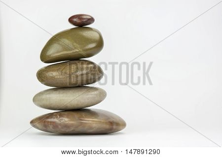 Pile of colourful boulders of natural stone on a white background