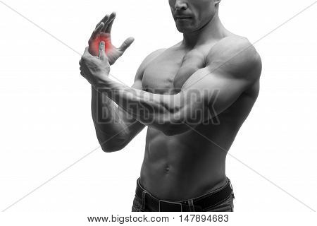 Pain in hand carpal tunnel syndrome muscular male body studio isolated shot on white background with red dot black and white photography