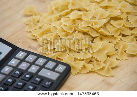 Calulator With Pasta On Wooden Background, Calories